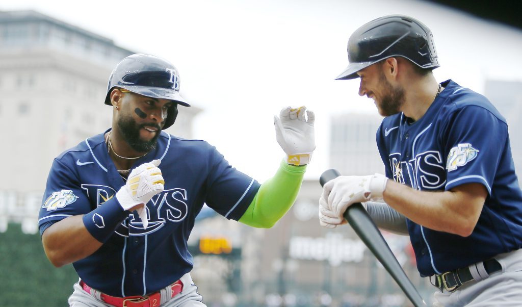 Yandy Diaz of the Tampa Bay Rays celebrates with Brandon Lowe after hitting a two-run home run during the second inning against the Detroit Tigers Comerica Park.