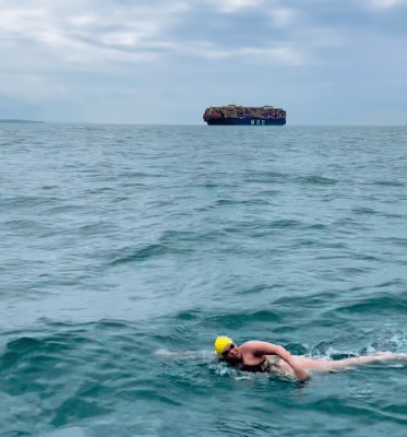 woman in white swim cap swimming in English Channel