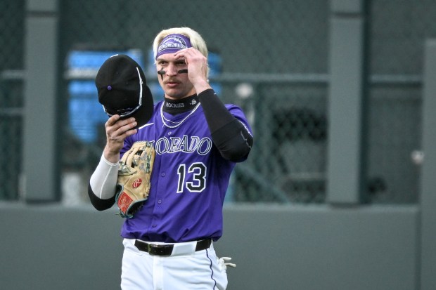 Zac Veen (13) of the Colorado Rockies adjusts his cap during the first inning against the Milwaukee Brewers at Coors Field in Denver on Tuesday, April 8, 2025. (Photo by AAron Ontiveroz/The Denver Post)