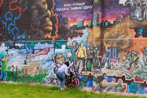 Fredricka Gray, twin sister of Freddie Gray, places a memorial wreath by a Freddie mural in the  Sandtown-Winchester neighborhood of Baltimore, MD on April 19, 2025. Mayor Brandon Scott, Attorney William H. “Billy” Murphy, Jr., and Fredricka Gray spoke for the 10 year anniversary since the killing of Freddie Gray.