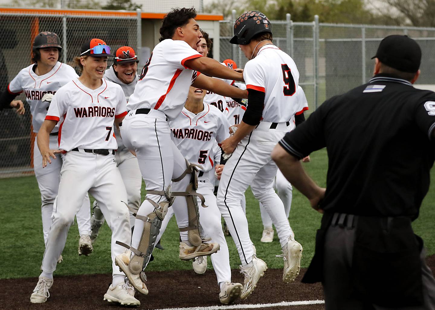 McHenry catcher Kyle Maness pushes his teammate, Carver Cohn, as he celebrates Cohn (right) scoring the game winning run during a Fox Valley Conference baseball game against Crystal Lake Central  on Friday, May 2, 2025, at McHenry High School.