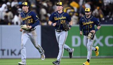 Milwaukee Brewers left fielder Christian Yelich (22) runs to the infield alongside right fielder Joey Wiemer (28) and center fielder Garrett Mitchell (5)
