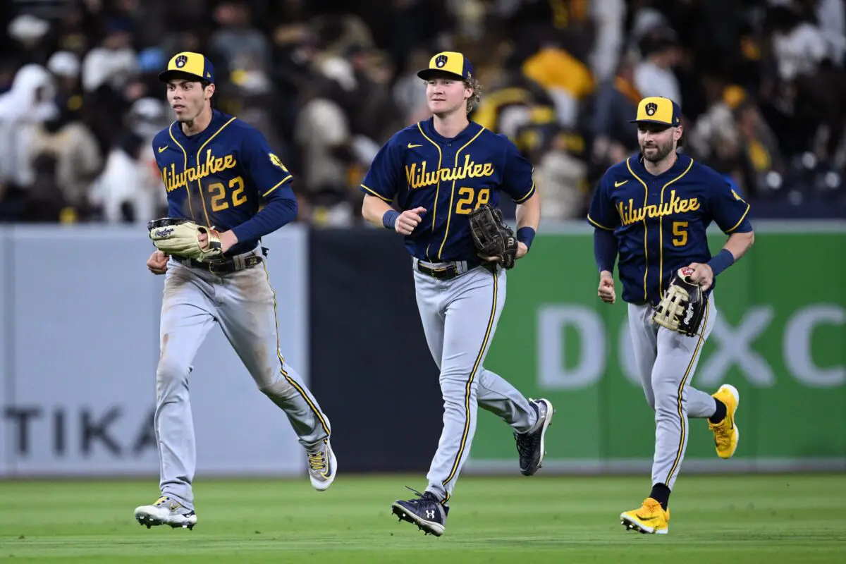 Milwaukee Brewers left fielder Christian Yelich (22) runs to the infield alongside right fielder Joey Wiemer (28) and center fielder Garrett Mitchell (5)