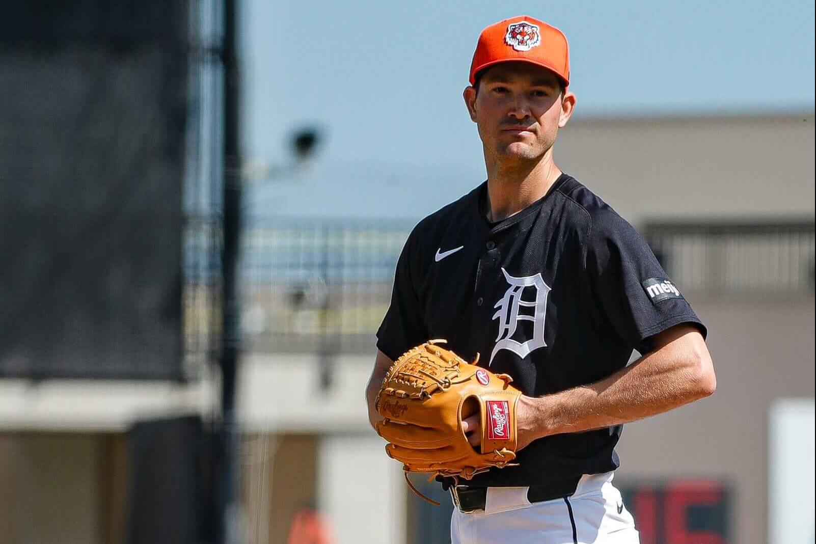 Detroit Tigers pitcher Drew Anderson, in an orange cap, navy Detroit jersey with a white script D and white pants, throws during spring training.