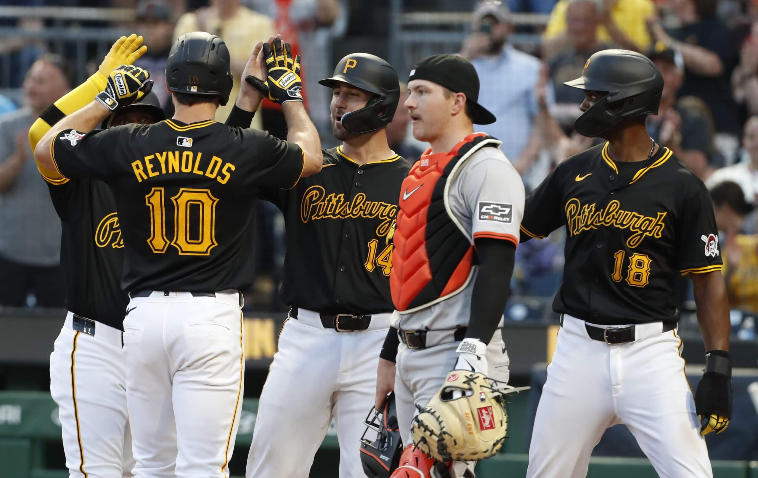 Pittsburgh Pirates left fielder Bryan Reynolds (10) celebrates his grand slam home run with designated hitter Andrew McCutchen (hidden), catcher Joey Bart (14) and outfielder Michael A. Taylor (18) against the San Francisco Giants during the fourth inning at PNC Park.