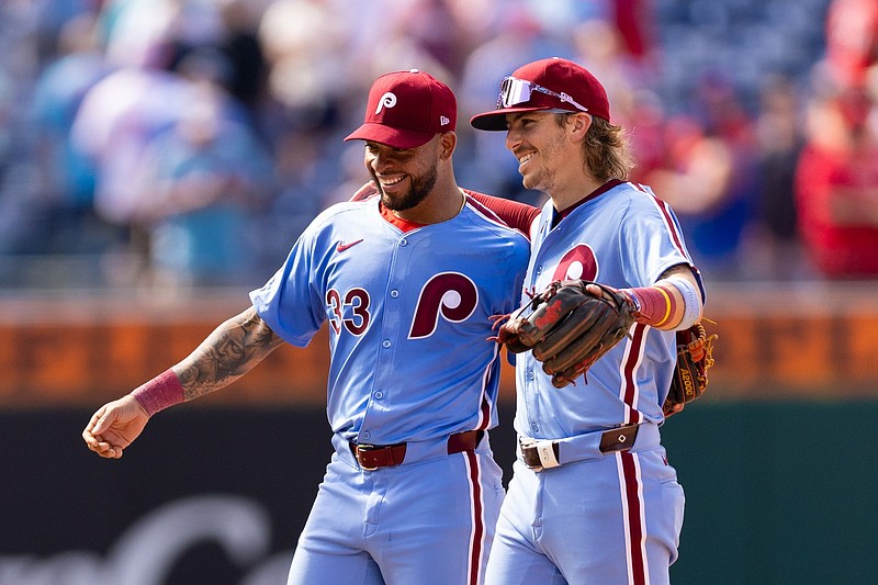 May 23, 2024; Philadelphia, Pennsylvania, USA; Philadelphia Phillies shortstop Edmundo Sosa (33) and second base Bryson Stott (5) celebrate a victory against the Texas Rangers at Citizens Bank Park. Mandatory Credit: Bill Streicher-USA TODAY Sports