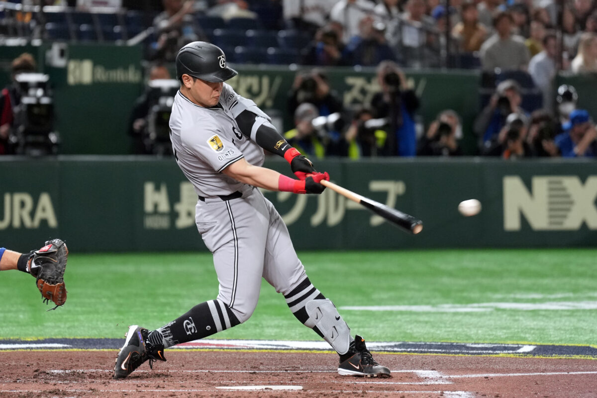 Mar 16, 2025; Bunkyo, Tokyo, Japan; Yomiuri Giants first baseman Kazuma Okamoto (25) hits a single against the Chicago Cubs during the second inning at Tokyo Dome. Mandatory Credit: Darren Yamashita-Imagn Images