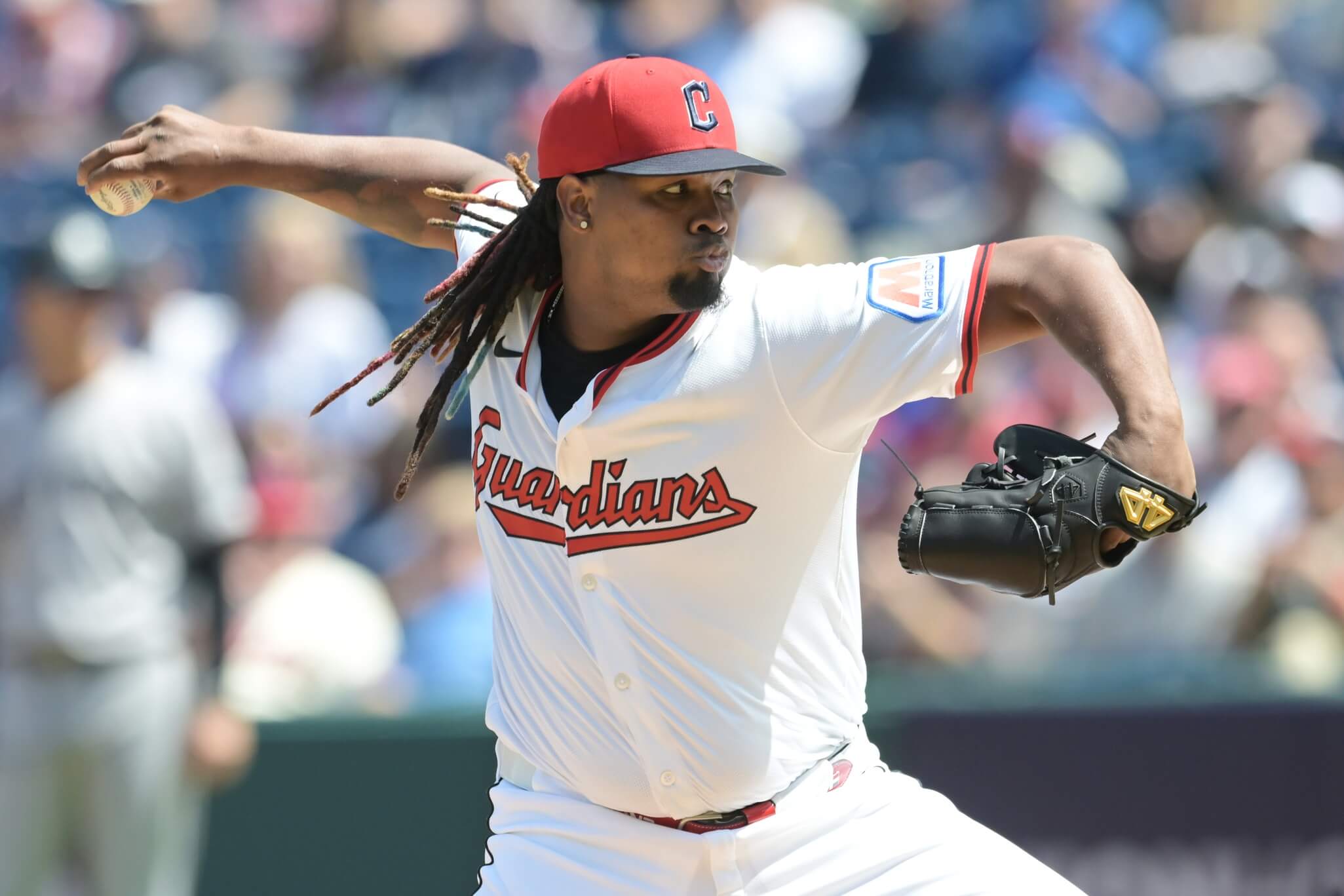 Luis Ortiz holds a baseball in his right hand while throwing a pitch.