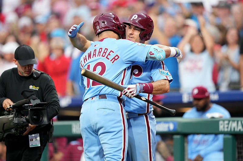 Aug 28, 2025; Philadelphia, Pennsylvania, USA; Philadelphia Phillies designated hitter Kyle Schwarber (12) reacts with catcher J.T. Realmuto (10) after hitting a home run against the Atlanta Braves in the first inning at Citizens Bank Park. Mandatory Credit: Kyle Ross-Imagn Images