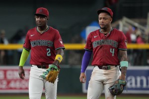 Sep 3, 2025; Phoenix, Arizona, USA; Arizona Diamondbacks shortstop Geraldo Perdomo (2) and Arizona Diamondbacks second base Ketel Marte (4) react after getting called for infielder interference in the seventh inning against the Texas Rangers at Chase Field. Mandatory Credit: Rick Scuteri-Imagn Images