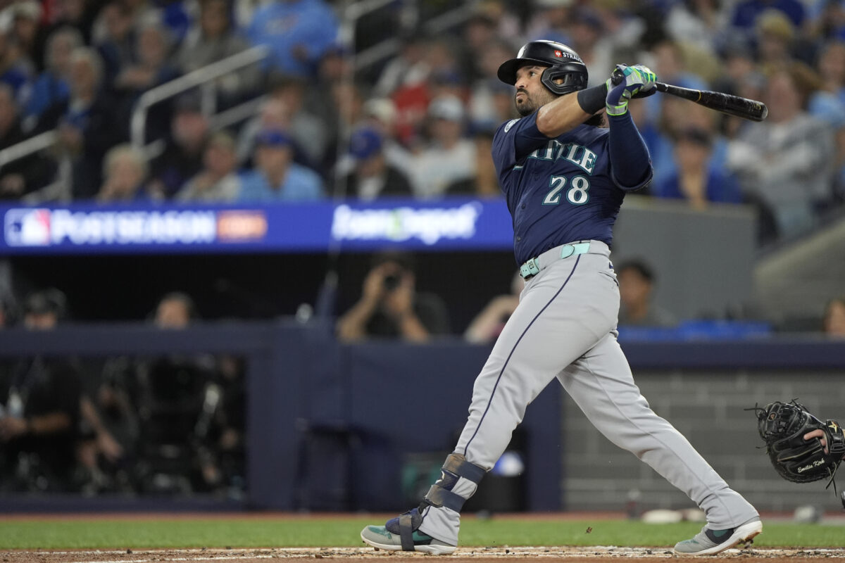 Oct 20, 2025; Toronto, Ontario, CAN; Seattle Mariners third baseman Eugenio Suarez (28) hits a single against the Toronto Blue Jays in the second inning during game seven of the ALCS round for the 2025 MLB playoffs at Rogers Centre.