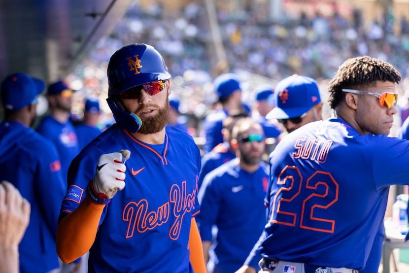 New York Mets' Brandon Nimmo (9) celebrates in the dugout after scoring during the seventh...