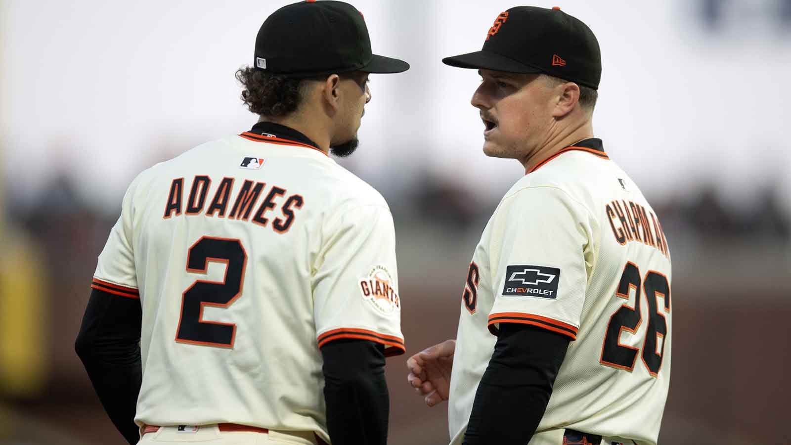 San Francisco Giants shortstop Willy Adames (2) and third baseman Matt Chapman (26) confer during the sixth inning against the San Diego Padres at Oracle Park.