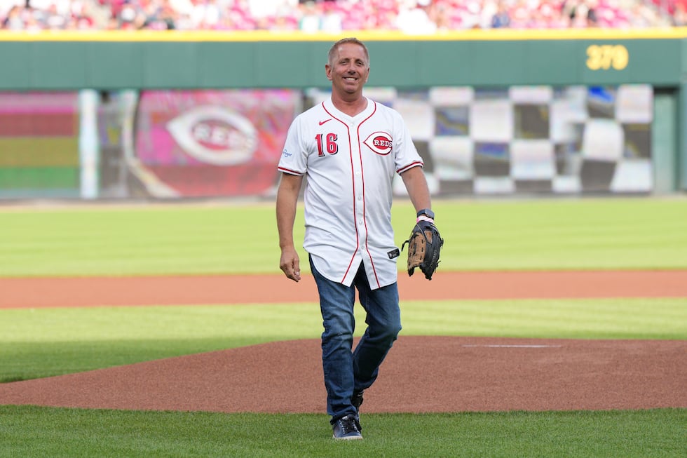 NASCAR driver Greg Biffle reacts after throwing the first pitch prior to a baseball game...