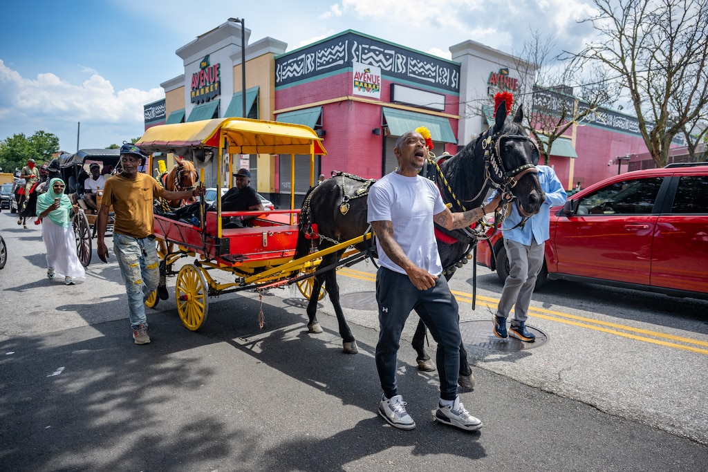 Levar Mullen calls out, “Fruit man, fruit man!,” as he leads the funeral procession down Pennsylvania Avenue for Bilal “BJ” Abdullah, the beloved arabber fatally shot by Baltimore Police this week.