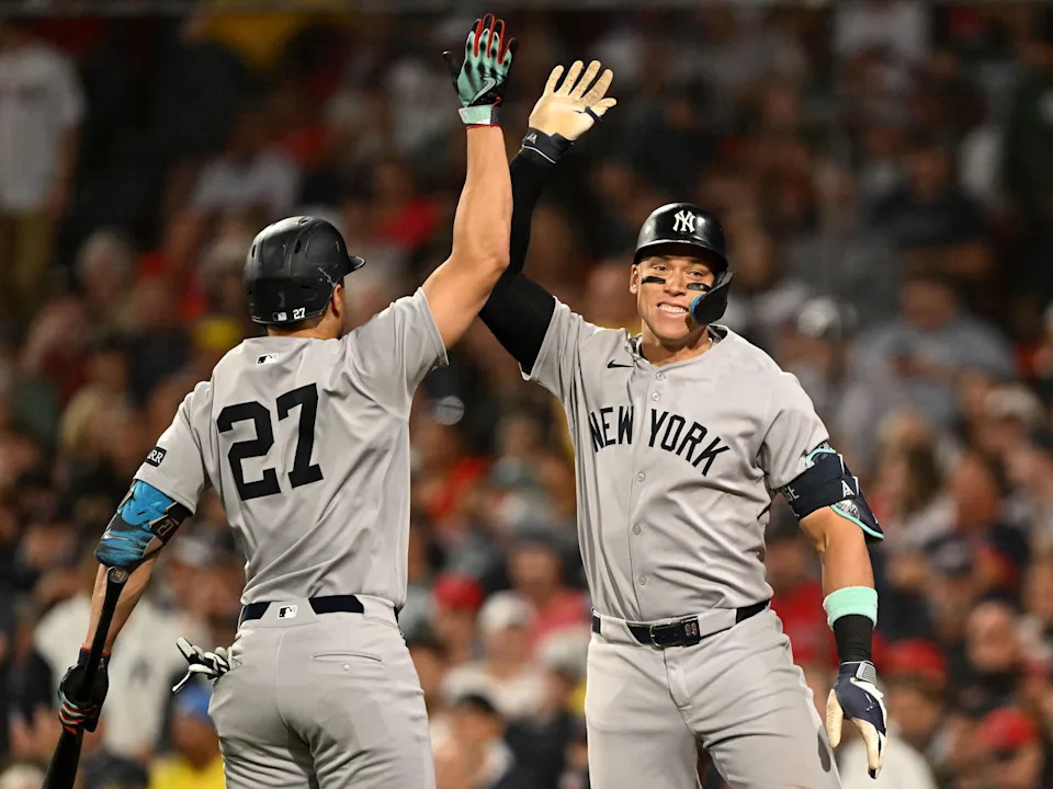 Sep 14, 2025; Boston, Massachusetts, USA; New York Yankees right fielder Aaron Judge (99) high-fives designated hitter Giancarlo Stanton (27) after hitting a solo home run against the Boston Red Sox during the fifth inning at Fenway Park. (Brian Fluharty/Imagn Images)