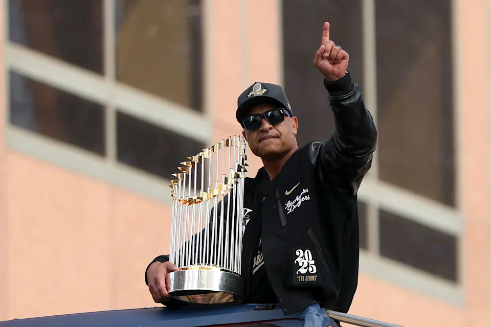 LOS ANGELES, CALIFORNIA - NOVEMBER 03: Manager Dave Roberts of the Los Angeles Dodgers reacts with the trophy atop a bus during the Los Angeles Dodgers World Series Parade on November 03, 2025 in Los Angeles, California. (Photo by Luke Hales/Getty Images)
