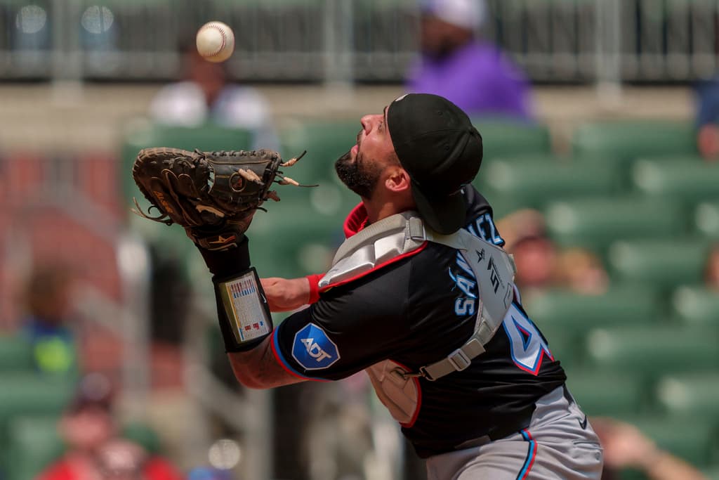 Miami Marlins catcher Ali Sánchez tracks a pop fly during a game against the Atlanta Braves on August 4, 2024, in Atlanta.