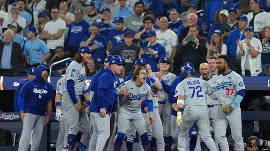 Los Angeles Dodgers second baseman Miguel Rojas (72) reacts after hitting a home run against the Toronto Blue Jays in the ninth inning for game seven of the 2025 MLB World Series at Rogers Centre. 