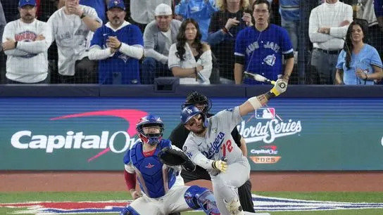 Los Angeles Dodgers second baseman Miguel Rojas (72) hits a home run against the Toronto Blue Jays in the ninth inning during game seven of the 2025 MLB World Series at Rogers Centre.