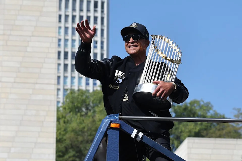 Manager Dave Roberts of the Los Angeles Dodgers celebrates on a bus with the Commissioner’s Trophy during the Dodgers 2025 World Series Championship parade on November 03, 2025. Getty Images
