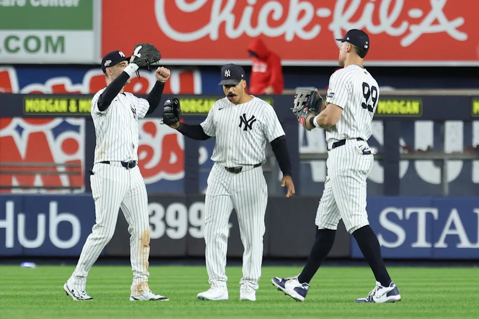 Oct 2, 2025; Bronx, New York, USA; New York Yankee outfielders Cody Bellinger (35), Trent Grisham (12) and Aaron Judge (99) react following game three of the Wildcard round for the 2025 MLB playoffs against the Boston Red Sox at Yankee Stadium. Mandatory Credit: Vincent Carchietta-Imagn Images