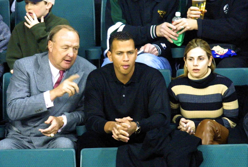 Texas Rangers owner Tom Hicks and newly signed shortstop Alex Rodriguez watch a Dallas Stars hockey game in December 2000.