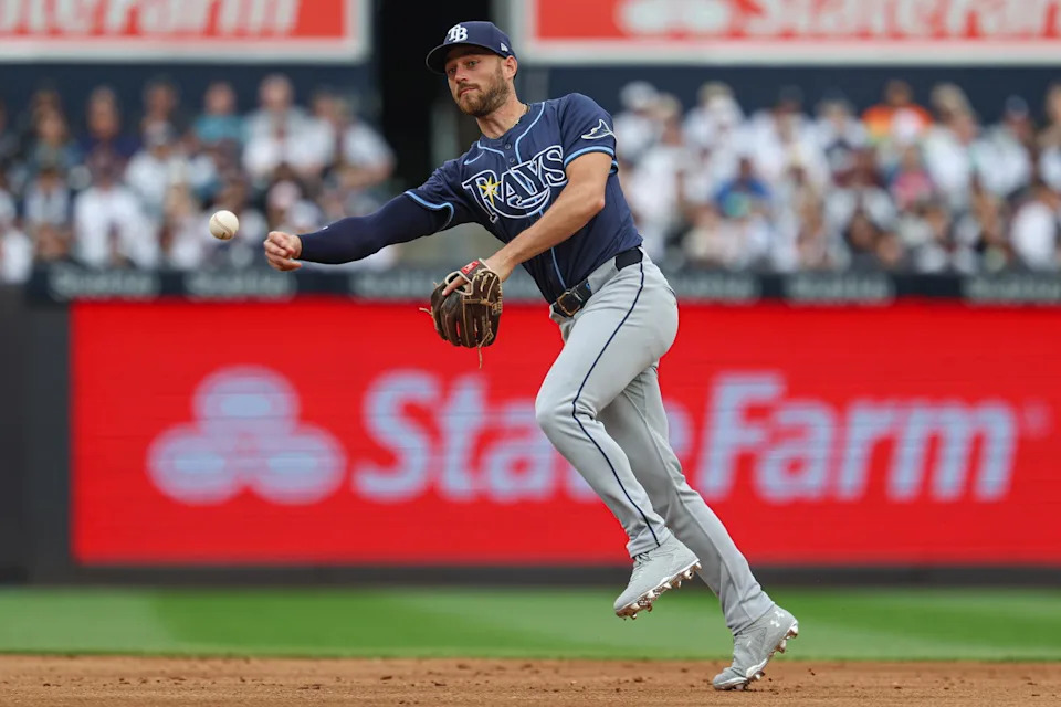 May 4, 2025; Bronx, New York, USA; Tampa Bay Rays second baseman Brandon Lowe (8) throws the ball to first base for an out during the second inning against the New York Yankees at Yankee Stadium. Mandatory Credit: Vincent Carchietta-Imagn Images