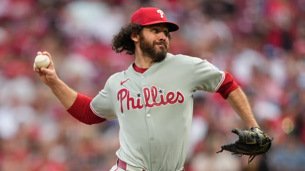 A baseball pitcher in the middle of throwing to the plate from the mound