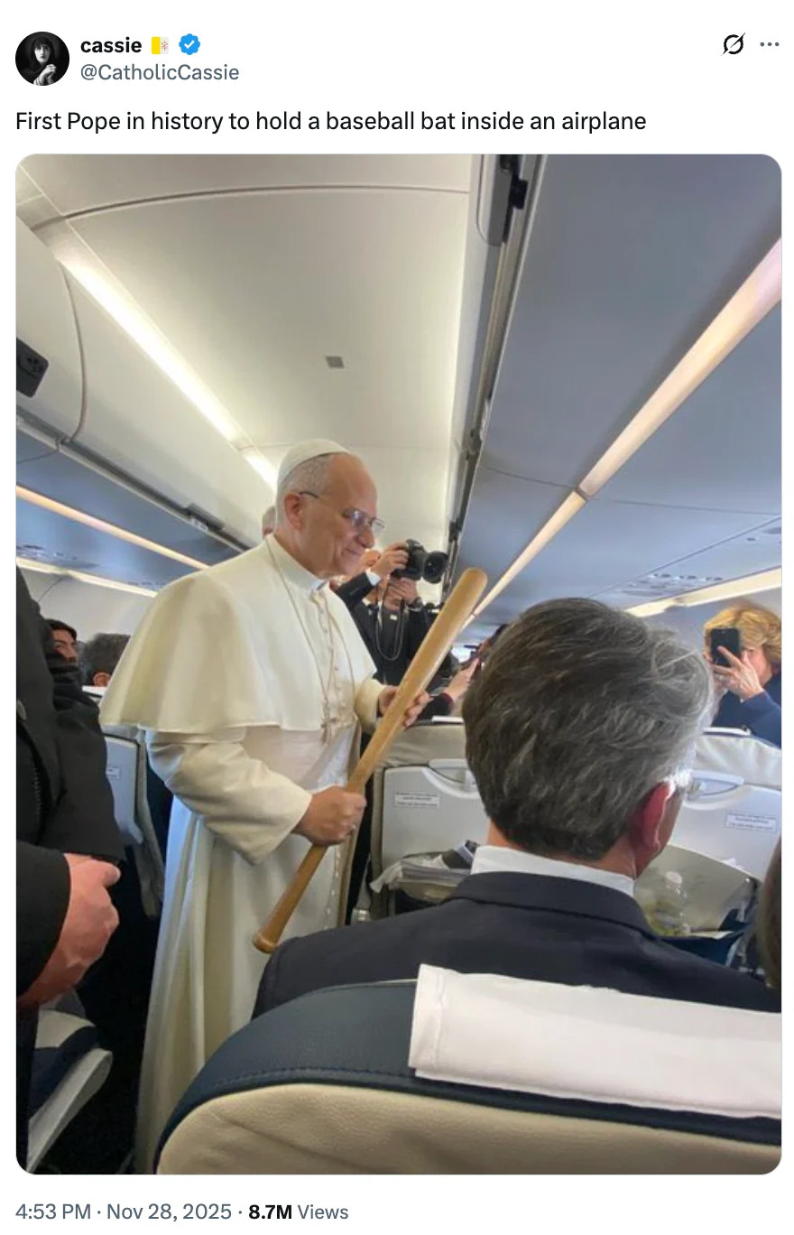 Person dressed as a Pope on a plane humorously holding a baseball bat, surrounded by seated passengers