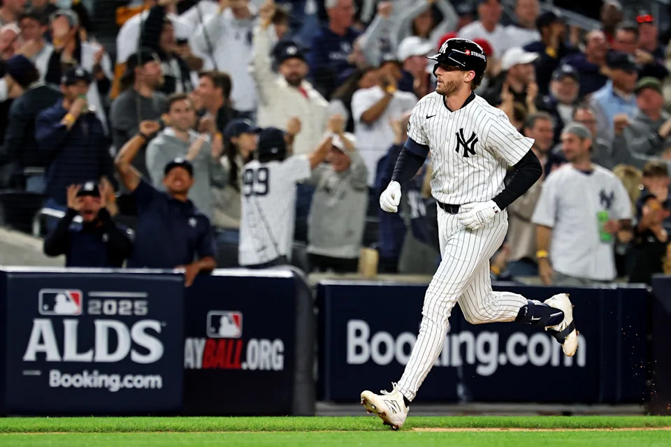 Oct 8, 2025; Bronx, New York, USA; New York Yankees third baseman Ryan McMahon (19) hits a solo home run during the third inning against the Toronto Blue Jays during game four of the ALDS round for the 2025 MLB playoffs at Yankee Stadium. Mandatory Credit: Vincent Carchietta-Imagn Images
