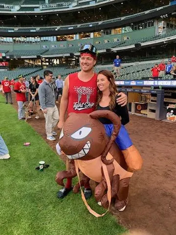 Jordyn Pagan, the wife of Cincinnati Reds closer Emilio Pagan, wears a cockroach costume as the Cincinnati Reds celebrate clinching a playoff spot in Milwaukee on Sept. 28.