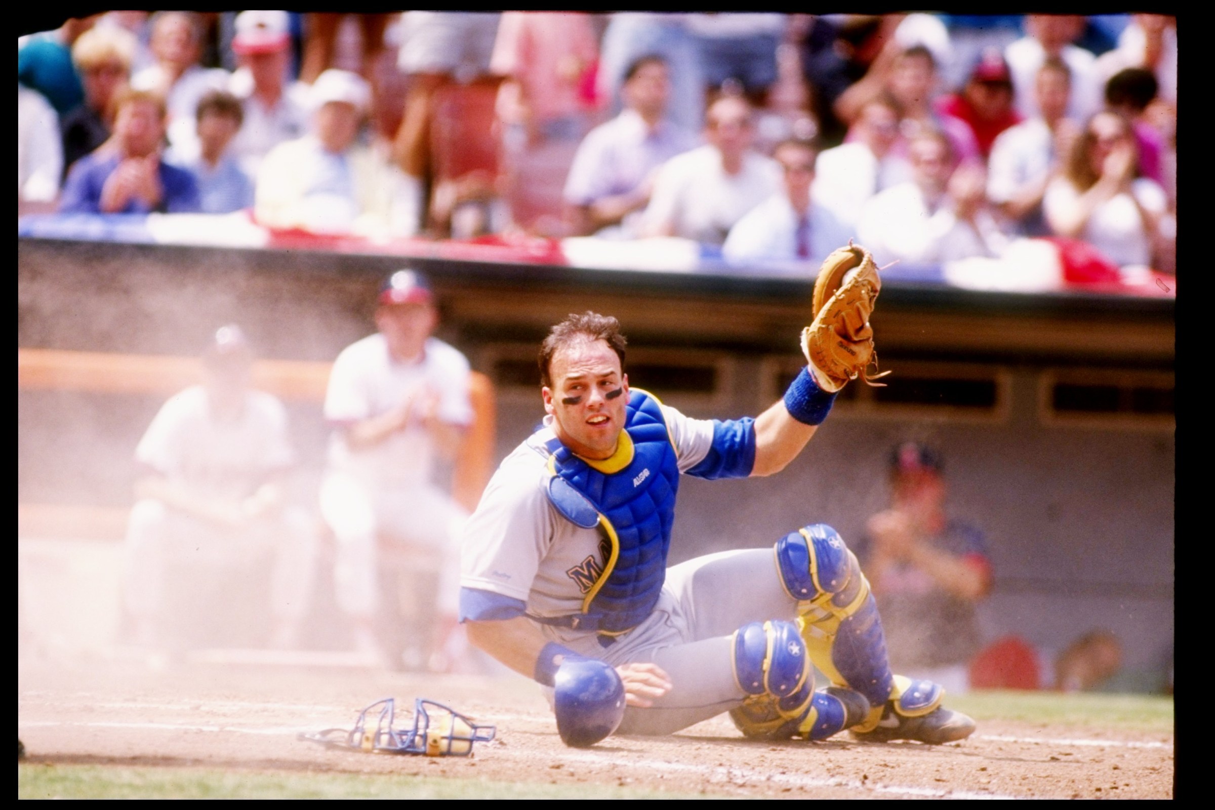 24 Apr 1991: Catcher Dave Valle of the Seattle Mariners sits on the ground with his glove raised in the air during a game against the California Angels at Anaheim Stadium in Anaheim, California. Mandatory Credit: Stephen Dunn /Allsport