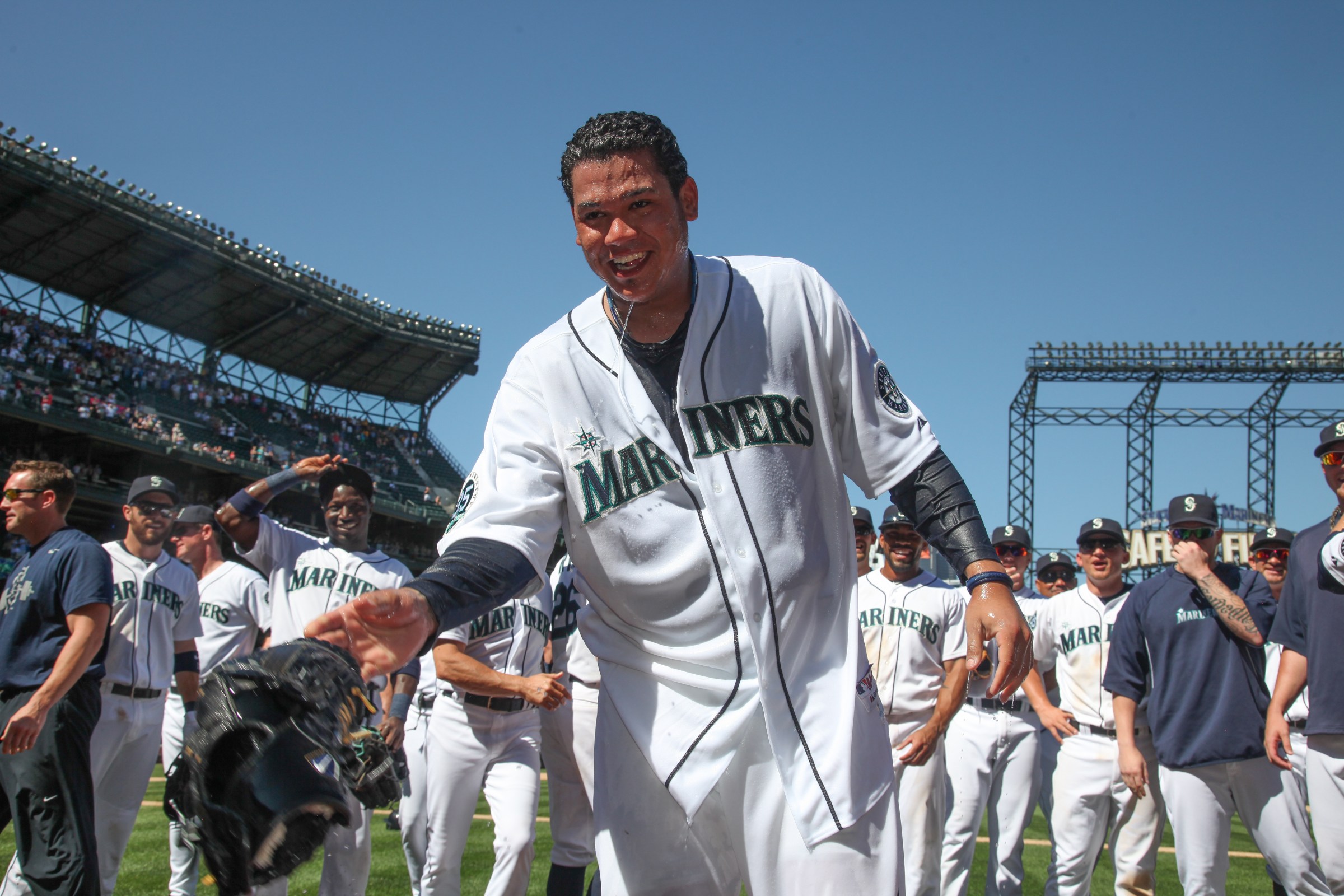 SEATTLE, WA - AUGUST 15: Starting pitcher Felix Hernandez #34 of the Seattle Mariners was dowsed with water after throwing a perfect game against the Tampa Bay Rays at Safeco Field on August 15, 2012 in Seattle, Washington. (Photo by Otto Greule Jr/Getty Images)