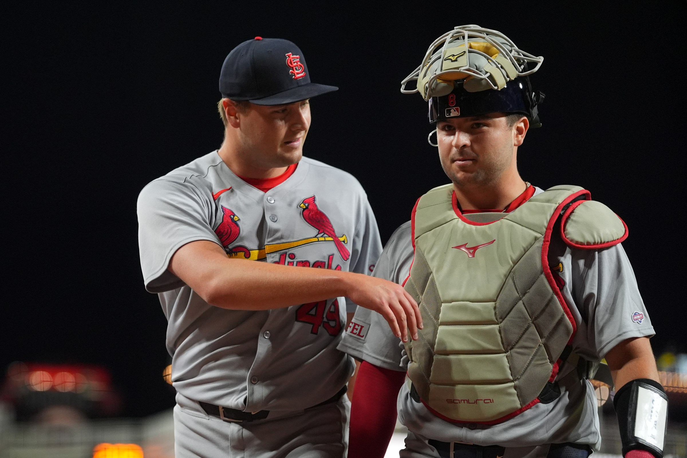 CINCINNATI, OHIO - AUGUST 29: Matt Svanson #49 of the St. Louis Cardinals talks with Jimmy Crooks #8 of the St. Louis Cardinals as they walk off the field after the ninth inning against the Cincinnati Reds at Great American Ball Park on August 29, 2025 in Cincinnati, Ohio. Jimmy Crooks #8 of the St. Louis Cardinals made his MLB debut during the ninth inning. (Photo by Jason Mowry/Getty Images)