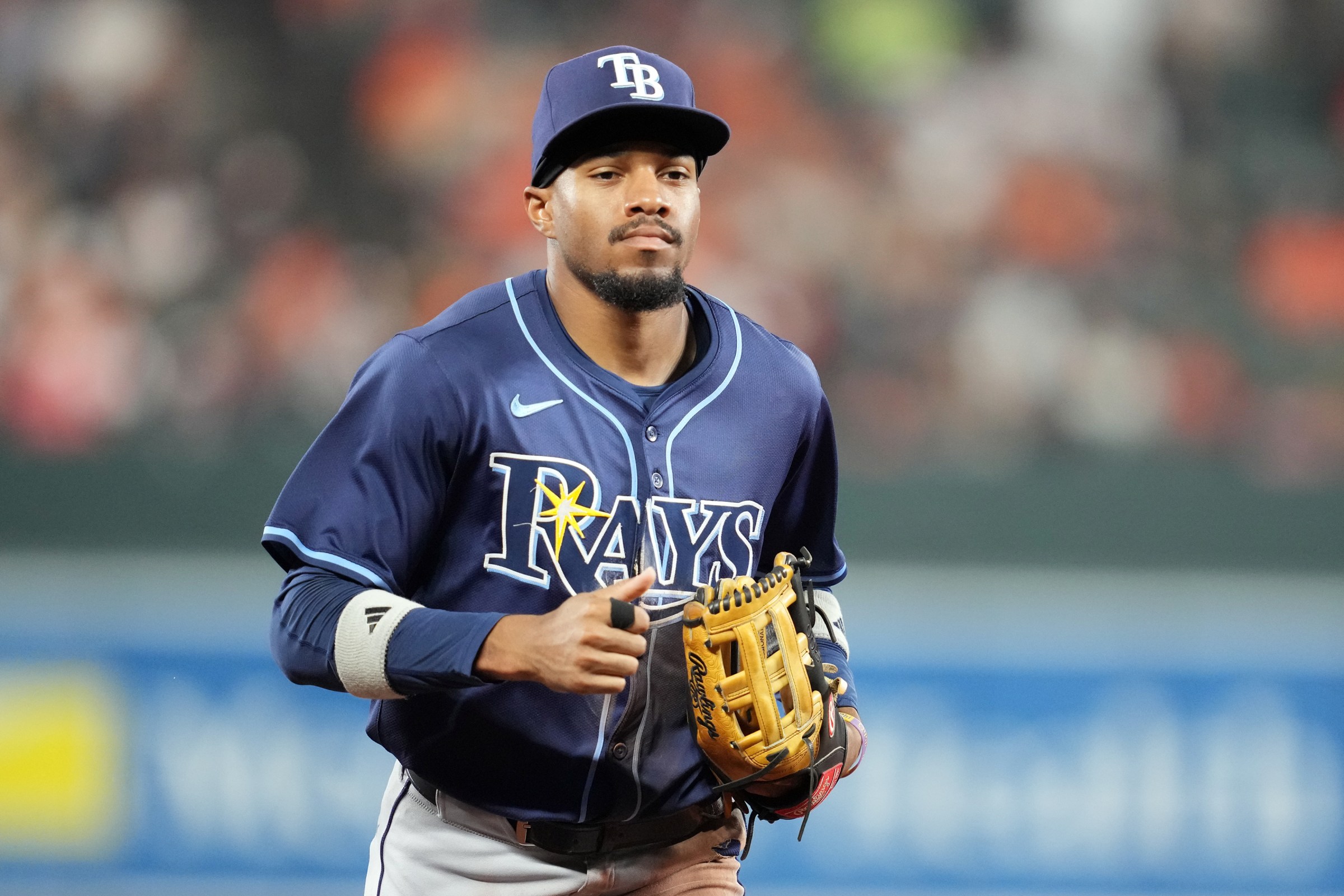 BALTIMORE, MD - SEPTEMBER 24: Chandler Simpson #14 of the Tampa Bay Rays runs back to the dugout out between inning during a baseball game against the Baltimore Orioles at the Oriole Park at Camden Yards on September 24, 2025 in Baltimore, Maryland. (Photo by Mitchell Layton/Getty Images)