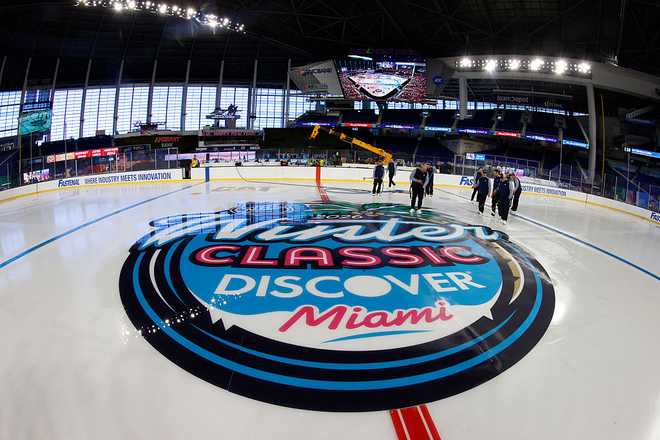 MIAMI, FLORIDA - DECEMBER 29:  NHL Ice Crew install lines and logos while Preparations continue for the 2028 Discover NHL Winter Classic - Rink Build Out at LoanDepot Park on December 29, 2025 in Miami, Florida. (Photo by Eliot J. Schechter/NHLI via Getty Images)