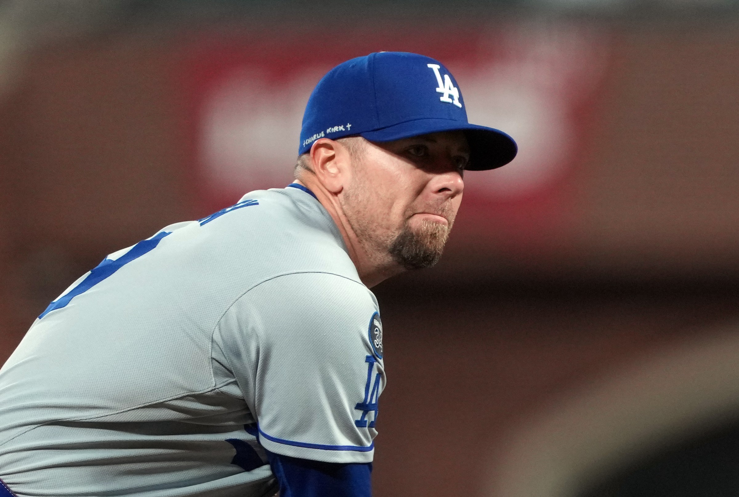 Sep 12, 2025; San Francisco, California, USA; Los Angeles Dodgers pitcher Blake Treinen (49) throws a pitch against the San Francisco Giants during the ninth inning as the name Charlie Kirk is written on his hat at Oracle Park. Mandatory Credit: Darren Yamashita-Imagn Images