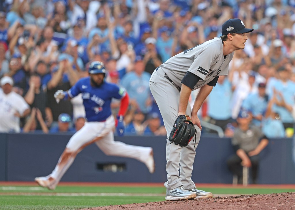 Yankees pitcher Max Fried (54) reacts as the Blue Jays' Vladimir Guerrero Jr. (27) scores on a Daulton Varsho double in Game 2 of the ALDS on Oct. 5, 2025.