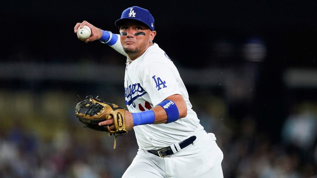 Los Angeles Dodgers shortstop Miguel Rojas throws to first for the out on a grounder by Milwaukee Brewers' Christian Yelich during the sixth inning of a baseball game Tuesday, Aug. 15, 2023, in Los Angeles. (AP Photo/Ryan Sun)