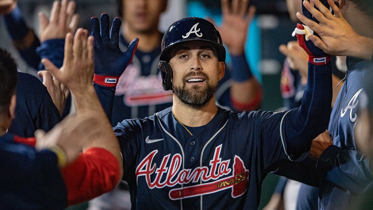 Ender Inciarte high-fives his teammates