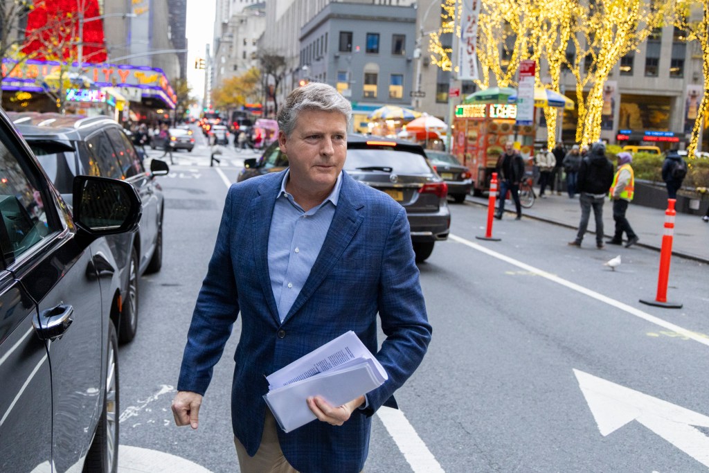 New York Yankees owner Hal Steinbrenner leaving MLB offices after an owner's meeting.