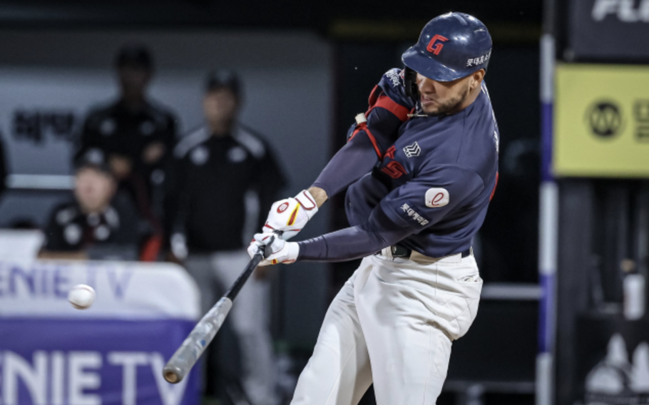 a left-handed hitter swinging to hit a baseball 