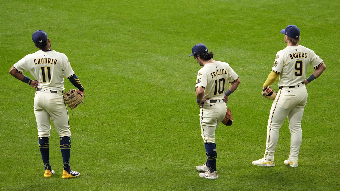 Oct 14, 2025; Milwaukee, Wisconsin, USA; Milwaukee Brewers center fielder Jackson Chourio (11), right fielder Sal Frelick (10) and first baseman Jake Bauers (9) stand in the outfield during a pitching change against the Los Angeles Dodgers in the eighth inning during game two of the NLCS round for the 2025 MLB playoffs at American Family Field. Mandatory Credit: Michael McLoone-Imagn Images