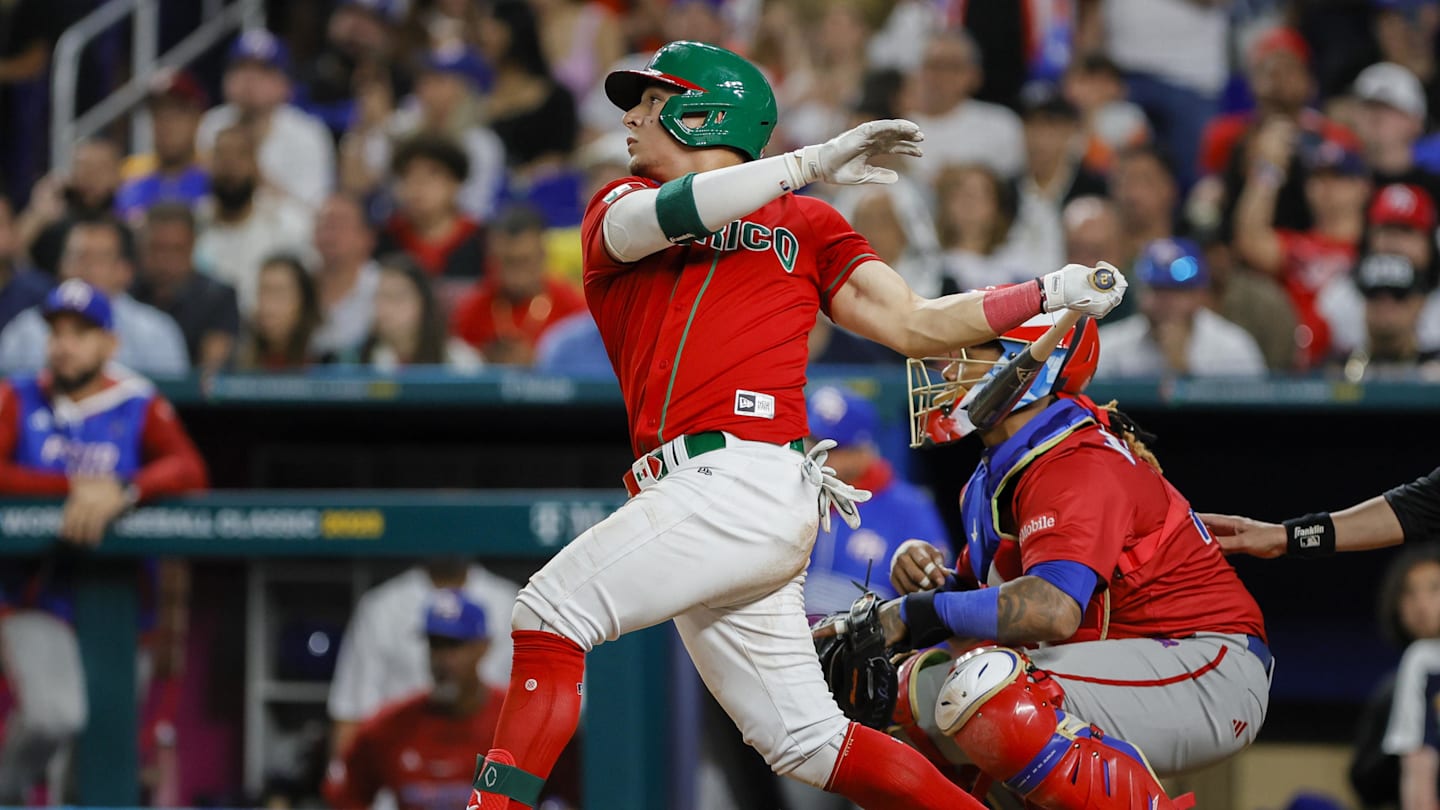 Mar 17, 2023; Miami, Florida, USA; Mexico second baseman Luis Urias (3) hits an RBI single during the seventh inning against Puerto Rico at LoanDepot Park. Mandatory Credit: Sam Navarro-Imagn Images