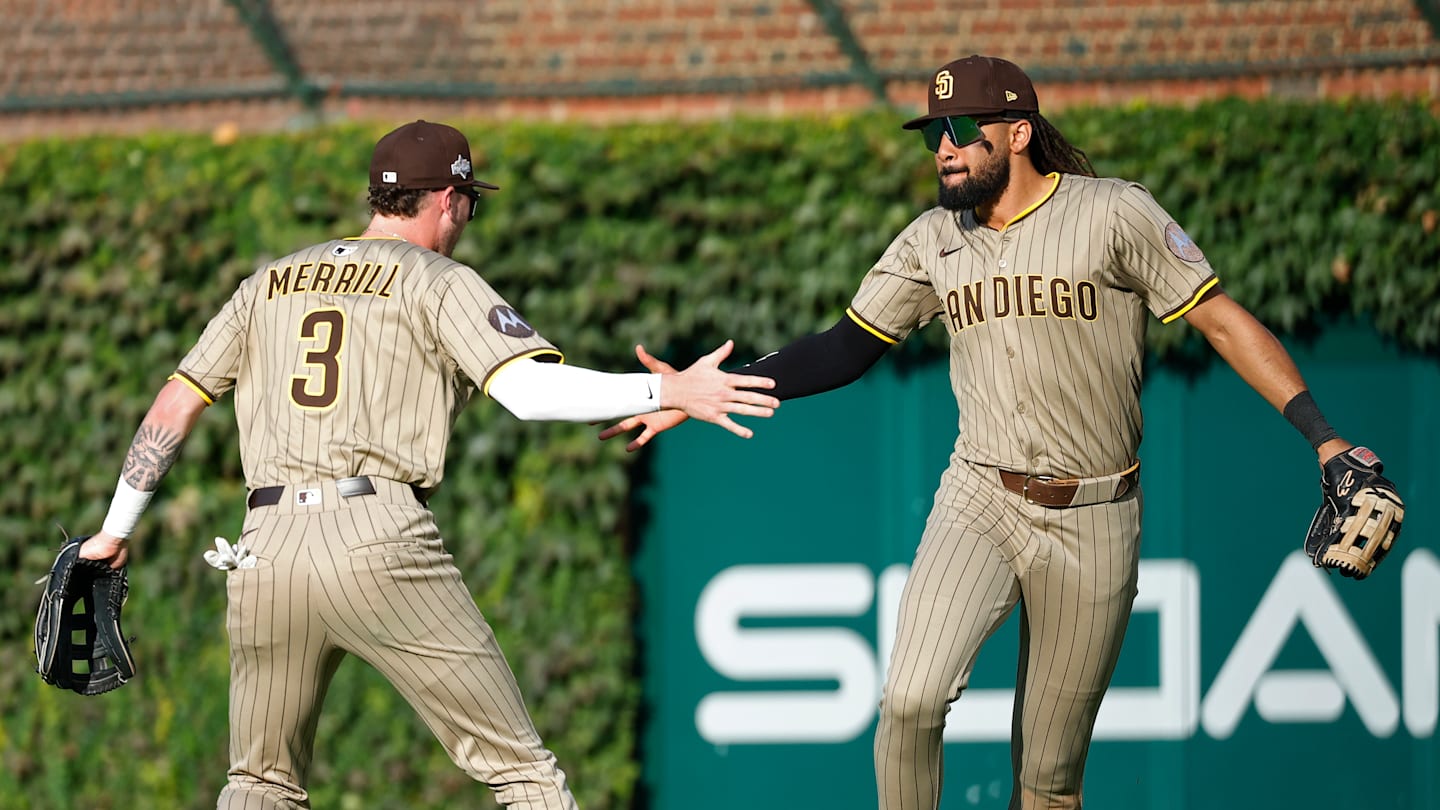 May 24, 2025; Atlanta, Georgia, USA; San Diego Padres right fielder Fernando Tatis Jr. (23) celebrates after a catch with center fielder Jackson Merrill (3) against the Atlanta Braves in the first inning at Truist Park. Mandatory Credit: Brett Davis-Imagn Images