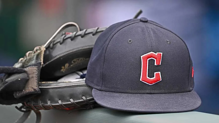 Guardians hat and glove on a railing balancing 