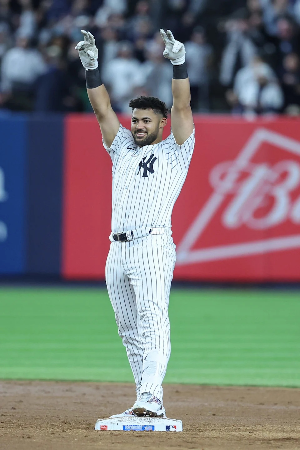New York Yankees left fielder Jasson Dominguez (24) gestures after hitting a three run double in the sixth inning against the Kansas City Royals at Yankee Stadium. All players wore #42 for Jackie Robinson Day.