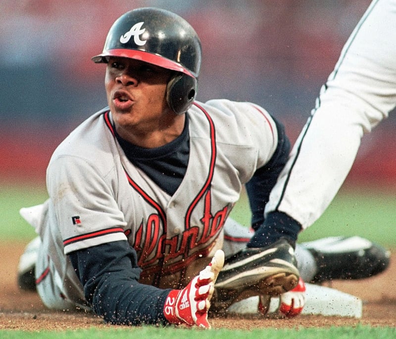 Atlanta Braves Andruw Jones slides safely into third base in the fourth inning against the Milwaukee Brewers in this  June 3, 1998 file photo, in Milwaukee.  The Atlanta Braves are cutting ties with Jones, saying they can't afford to keep the perennial Gold Glove center fielder who's spent his entire career with the organization. (AP Photo/Gary Dineen,file)