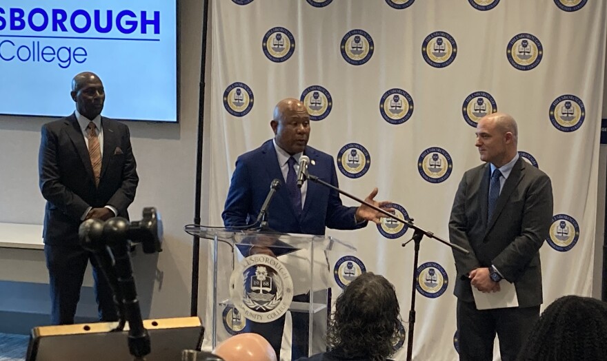 Three men at a podium